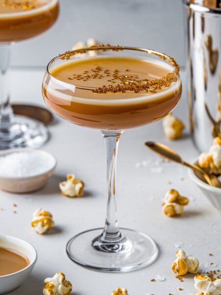 A luxurious Salted Caramel Martini in a chilled glass, rimmed with caramel and flaky sea salt, served with a rich, creamy texture.